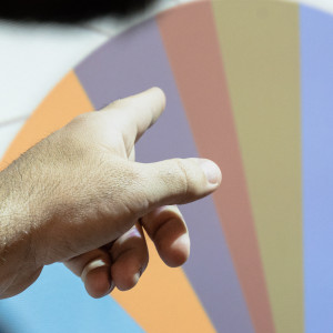 Finger pointed at a coloured graph in a presentation